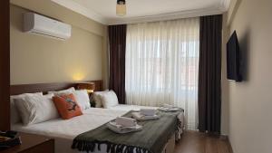 a hotel room with a bed with two dishes on it at cunda panorama otel in Ayvalık