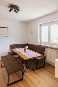 a dining room with a wooden table and benches at Haus Hermann in Schruns