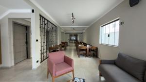 a living room with a couch and chairs and tables at Asa Hotel in Piracicaba