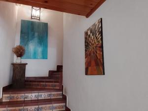 a painting on a wall next to some stairs at Mar e Sol in Vila Nova de Milfontes