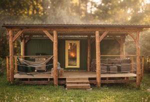 a wooden gazebo with a hammock on it at Maringotka Slaměnka u menhirového kruhu - U Slaměnky in Hněvětice +14 photos