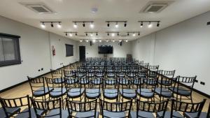 an empty room with chairs and a podium at Asa Hotel in Piracicaba