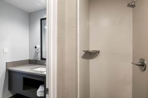 a bathroom with a sink and a mirror at Studio 6 Rosemead, CA in Rosemead +27 photos