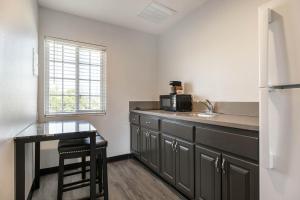 a kitchen with a counter and a sink and a refrigerator at Studio 6 Rosemead, CA in Rosemead