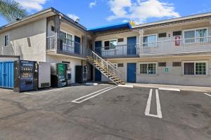 a parking lot in front of a building with a staircase at Studio 6 Rosemead, CA in Rosemead