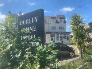 a building with a car parked in front of it at The Durley Chine Hotel in Bournemouth
