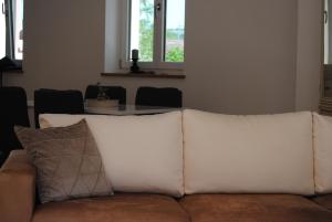 a white couch with pillows in a living room at MainApartment 1A in Margetshöchheim