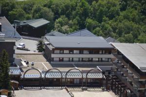 a large building with benches in front of it at Belledone in Les Menuires +4 photos