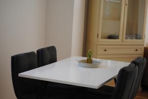 a white dining room table with chairs and a cabinet at MainApartment 1A in Margetshöchheim