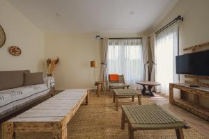 a living room with a couch and a table at Pods at Aloe Valley, Ngobit Laikipia in Gatunga