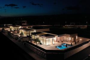 a lit up building with a pool at night at Villa Stone in Smoković