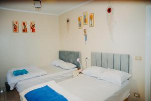 two beds sitting next to each other in a room at Tranquil Villa, private Pool, Garden, Wifi, Fayoum in Qaryat at Ta‘mīr as Siyāḩīyah +63 photos