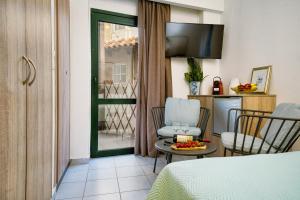 a room with a bed and a table with a plate of fruit at By Captains Studio in Ierapetra