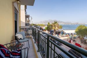a balcony with chairs and a view of the ocean at By Captains Studio in Ierapetra
