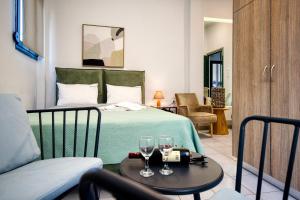 a bedroom with a bed and two glasses on a table at By Captains Studio in Ierapetra