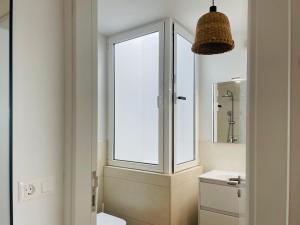 a bathroom with a window and a white sink at Casa Señora Reyes in Famara +5 photos