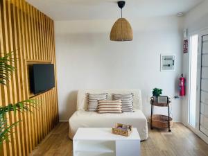 a living room with a couch and a tv at Casa Señora Reyes in Famara