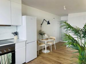 a kitchen with a table and a white refrigerator at Casa Señora Reyes in Famara