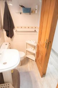 a small bathroom with a toilet and a sink at Casa para descubrir el mar in La Garita +31 photos