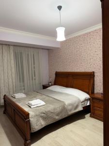a bedroom with a bed with two towels on it at Erebuni in Yerevan