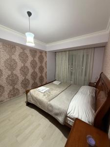 a bedroom with a bed and a table in it at Erebuni in Yerevan