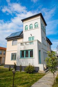 a large white building with a black roof at Harmony Boutique Villa in Siófok