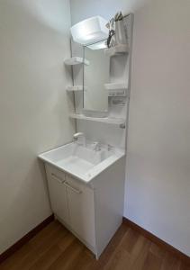 a bathroom with a sink and a mirror at Seaside accommodation - Vacation STAY 22044 in Horiechō