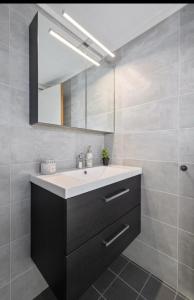 a bathroom with a sink and a mirror at Modern apartment with amazing location in Hol +14 photos