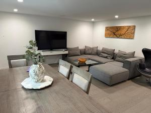 a living room with a couch and a table at 2BDRM-Kitchenette-BBQ-Smart TV-4-5Guest in West Vancouver