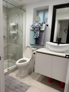 a bathroom with a toilet and a sink and a shower at 2BDRM-Kitchenette-BBQ-Smart TV-4-5Guest in West Vancouver +23 photos