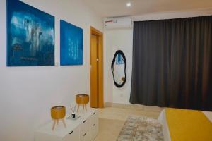 a bedroom with a bed and a mirror on the wall at Sea view beach apartment in Bijilo