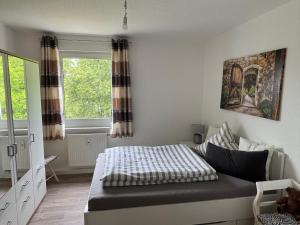 a bedroom with a bed and a window at Fewo Am Poetenteich in Jänkendorf
