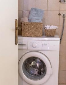 a washing machine with baskets on top of it at SunKipos in Paleros