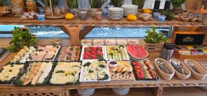 a buffet filled with lots of different types of food at Świstak Residence & Spa I Wake Up with Mountain View in Kościelisko