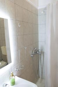 a bathroom with a shower with a toilet and a sink at SunKipos in Paleros +20 photos