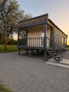 a tiny house with a porch and a bench at Panorama Hrytsulivka in Vorokhta