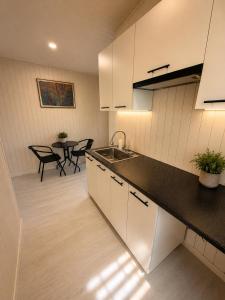 a kitchen with a sink and a table with chairs at Panorama Hrytsulivka in Vorokhta