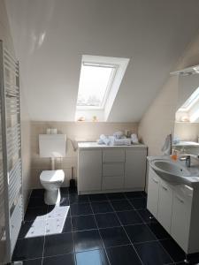 a bathroom with a toilet and a sink and a window at Hotel Guesthouse Stari Jasen in Zagreb +112 photos