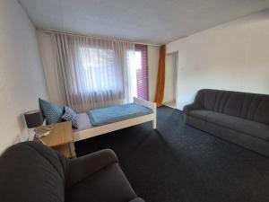 a living room with a bed and a couch at Monteurhaus Dautphe in Friedensdorf