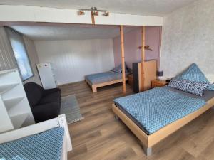 a small room with a bed and a couch at Monteurhaus Dautphe in Friedensdorf