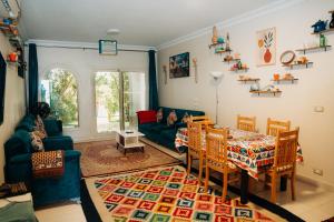a living room with a couch and a table and chairs at Tranquil Villa, private Pool, Garden, Wifi, Fayoum in Qaryat at Ta‘mīr as Siyāḩīyah