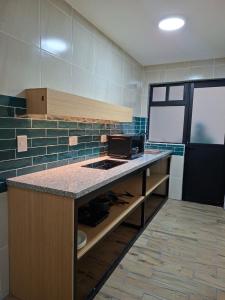 a kitchen with a counter with a stove in it at Hotel casa el Palomar - 3 in San Baltasar