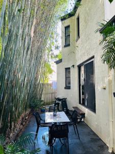 a patio with a table and chairs next to a building at Nicole Guest House - Private Room & Bathroom - 6kms from City in Brisbane