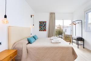 a bedroom with a large bed with blue pillows at Eden Rentals Oasis Boho 1 in Las Galletas +63 photos