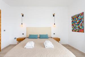 a bedroom with a bed with two towels on it at Eden Rentals Oasis Boho 1 in Las Galletas
