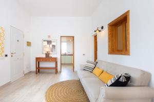 a living room with a couch and a table at Eden Rentals Oasis Boho 1 in Las Galletas