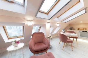 a living room with skylights and a table and chairs at Harmony Boutique Villa in Siófok