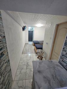 a hallway with a room with a couch and a table at BOMBA Apart in Târgu Secuiesc