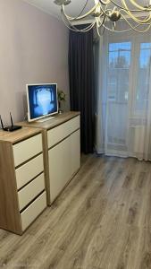 a room with a desk with a laptop computer on it at Butas in Mažeikiai
