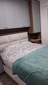 a bedroom with a bed with a green comforter at Cozy aparment Susanj,Bar in Bar